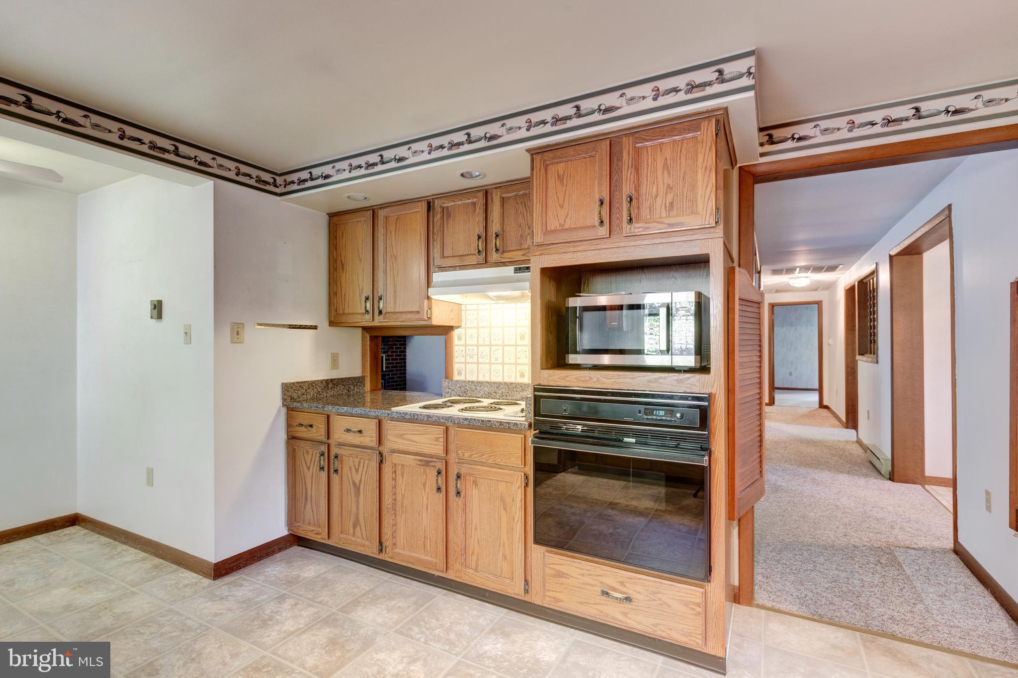 3870 Roop Road New Windsor, MD 21776 - Photo 2 of 59 a kitchen with stainless steel appliances granite countertop a stove and a refrigerator