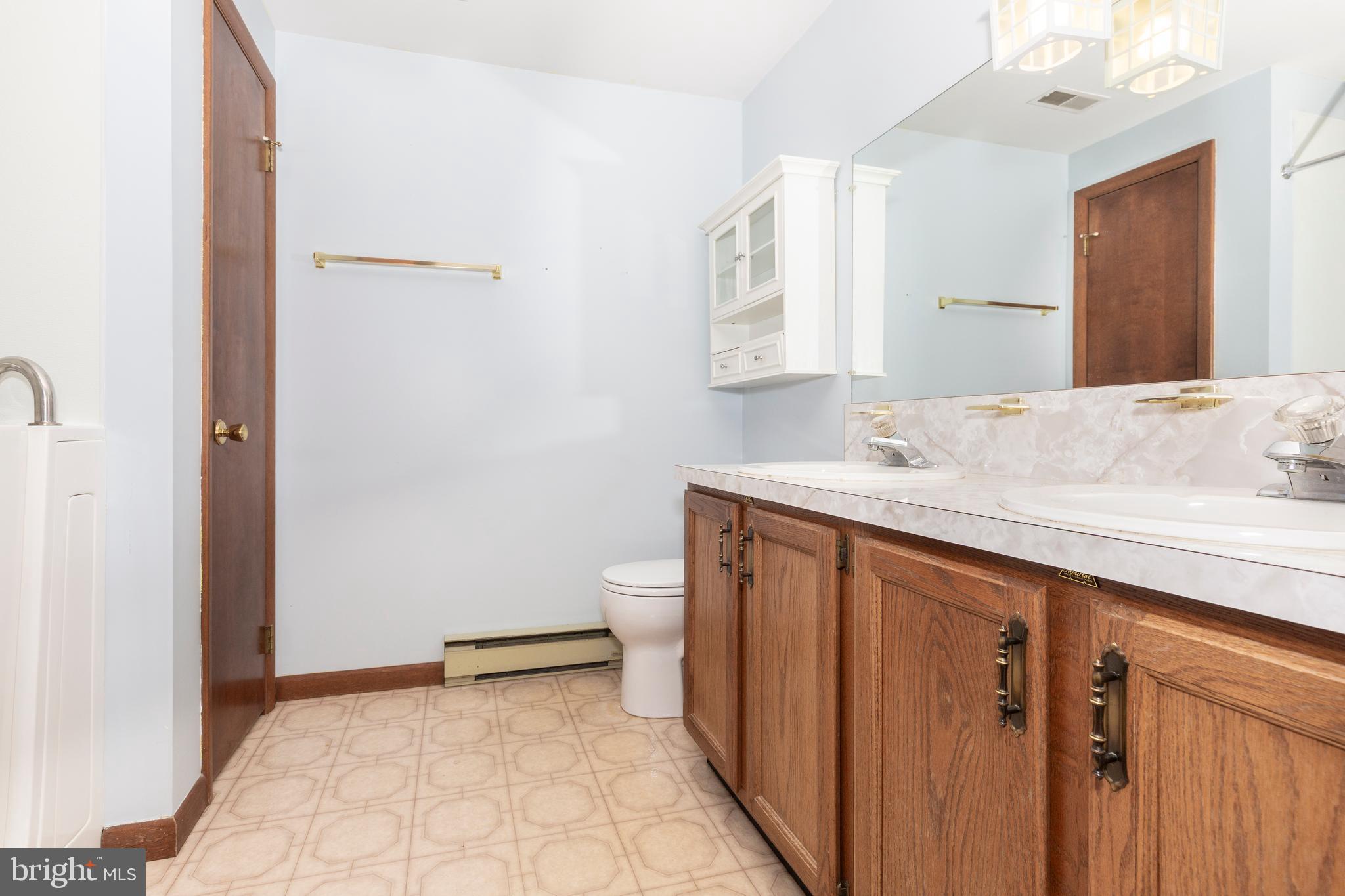 3870 Roop Road New Windsor, MD 21776 - Photo 21 of 59 a bathroom with a sink and a mirror