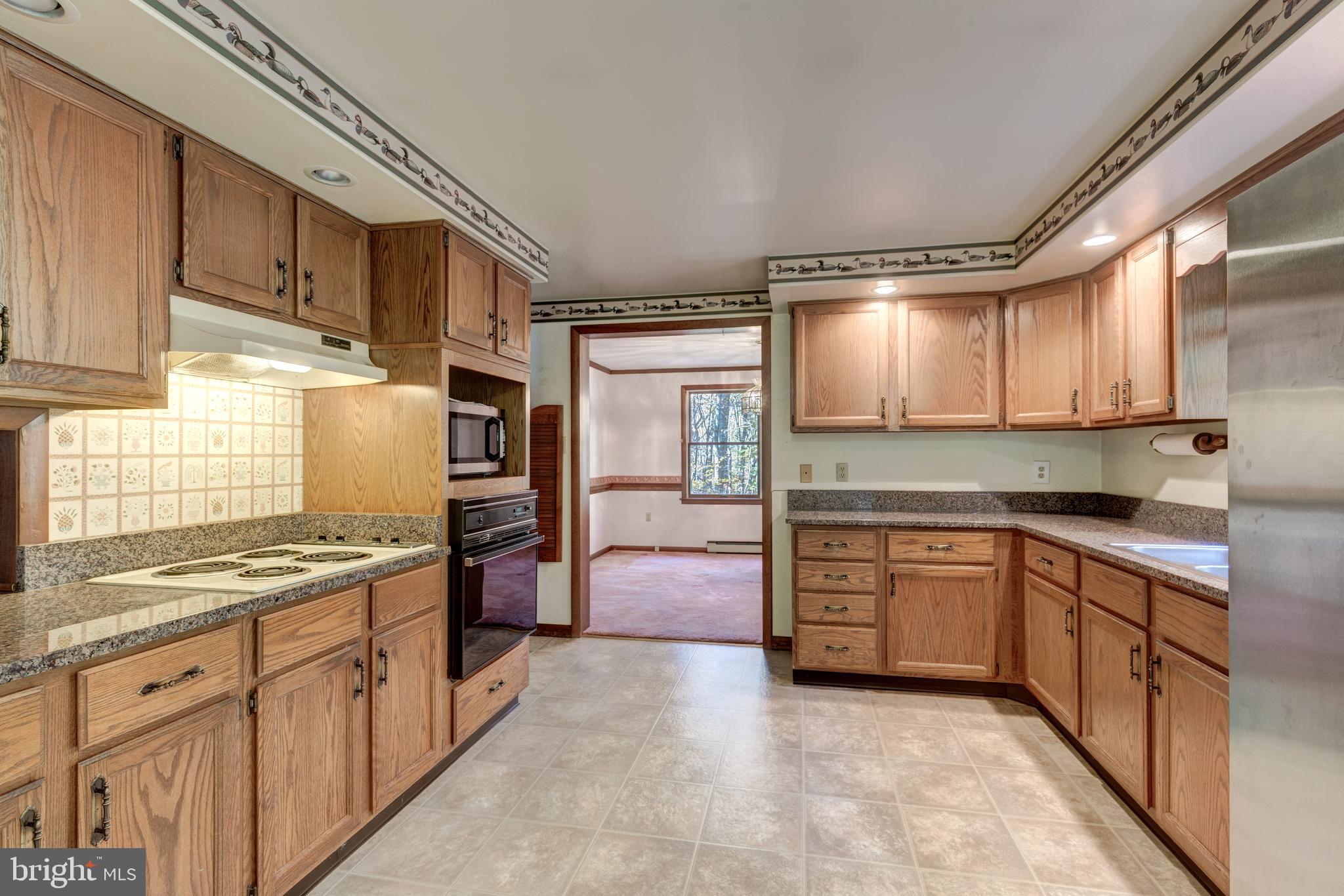 3870 Roop Road New Windsor, MD 21776 - Photo 3 of 59 a kitchen with stainless steel appliances granite countertop a stove a sink and a refrigerator