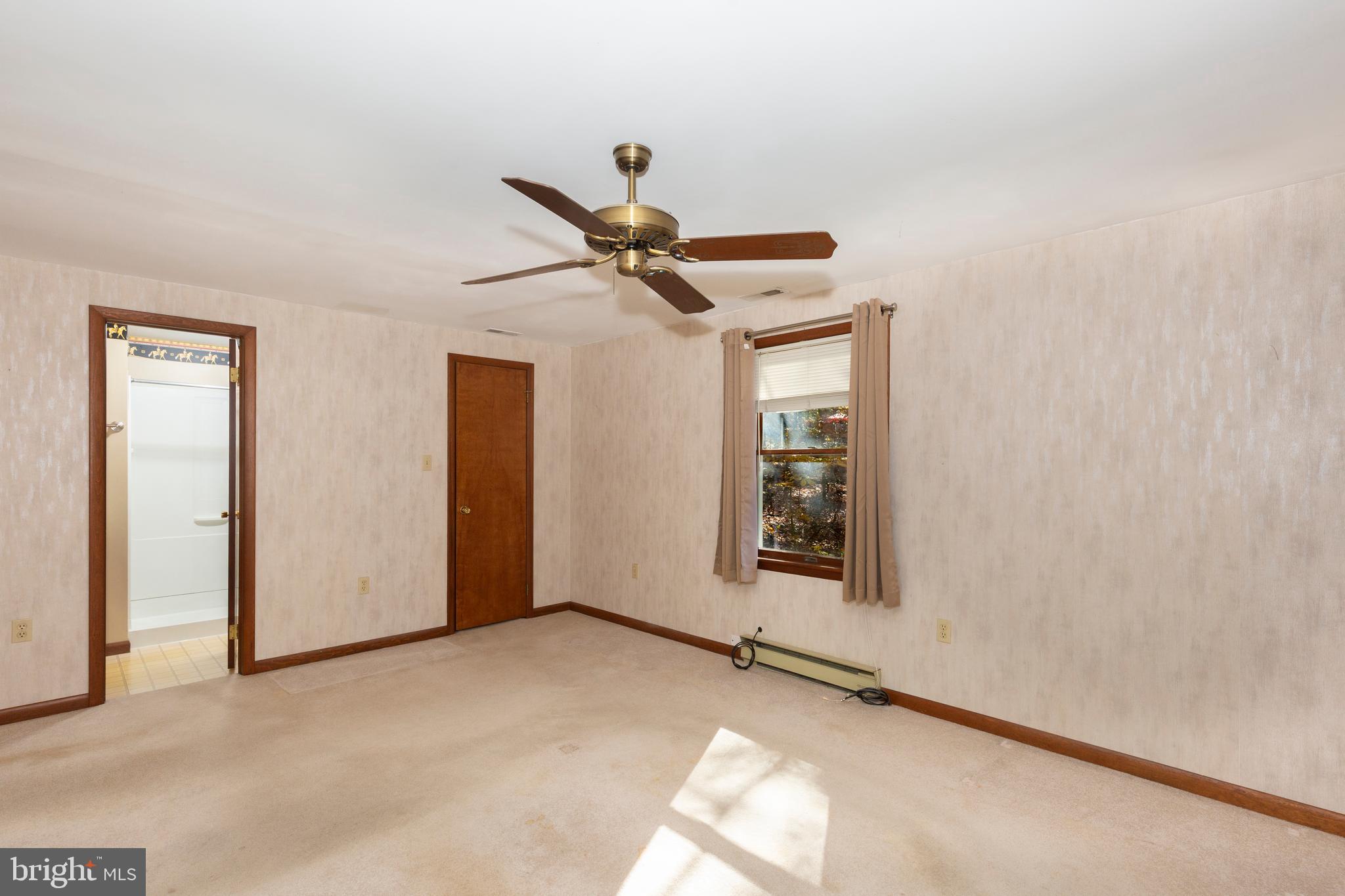 3870 Roop Road New Windsor, MD 21776 - Photo 35 of 59 a view of a livingroom with a ceiling fan and window