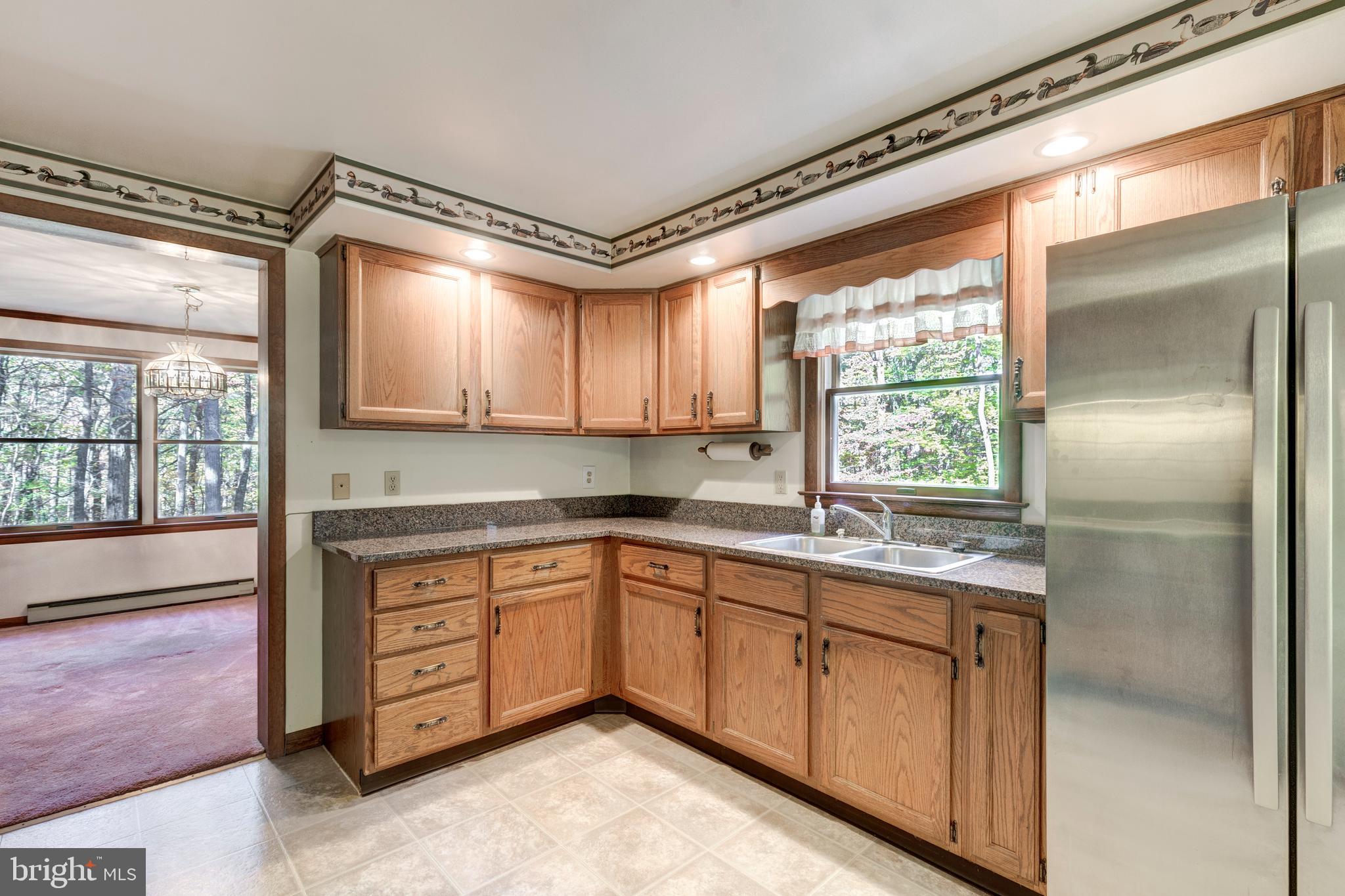 3870 Roop Road New Windsor, MD 21776 - Photo 4 of 59 a kitchen with a sink window and cabinets