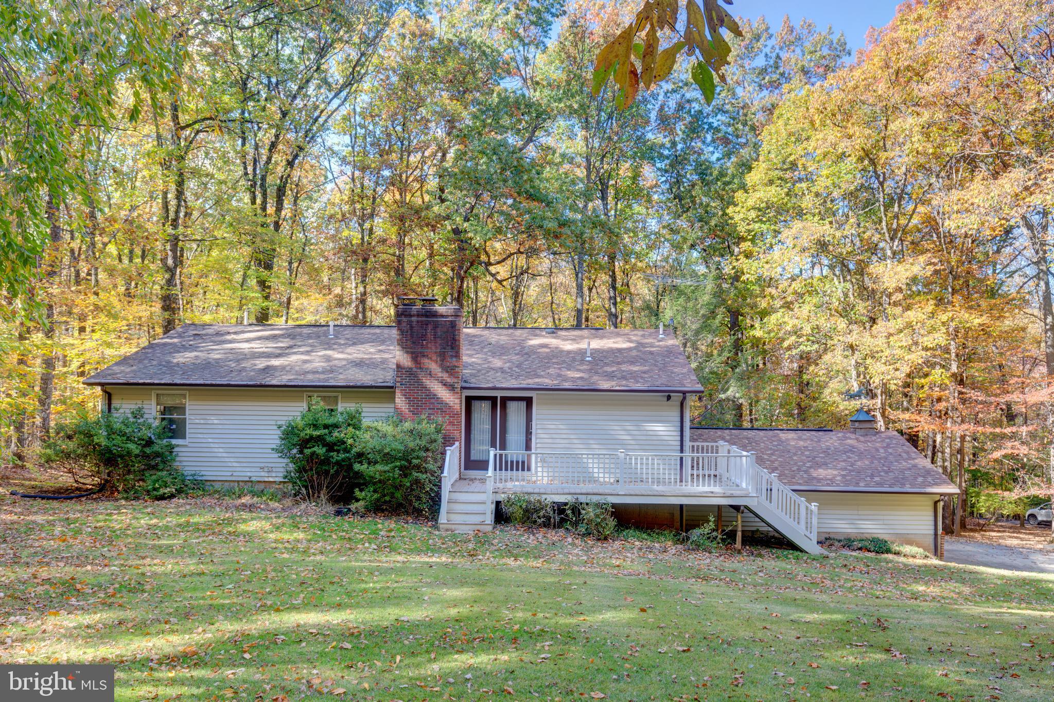 3870 Roop Road New Windsor, MD 21776 - Photo 52 of 59 a front view of a house with a garden and yard