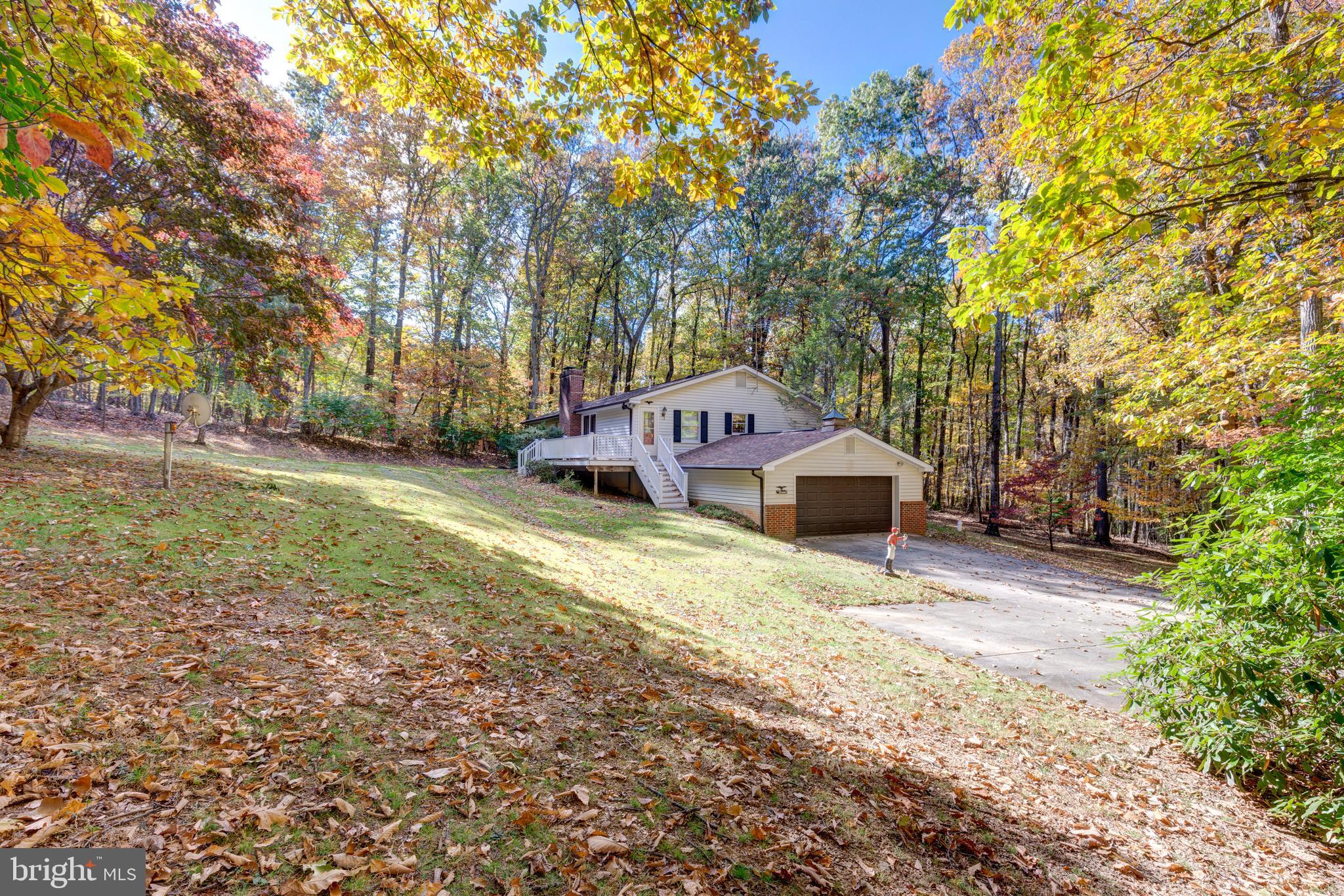 3870 Roop Road New Windsor, MD 21776 - Photo 57 of 59 a front view of a house with a yard and trees