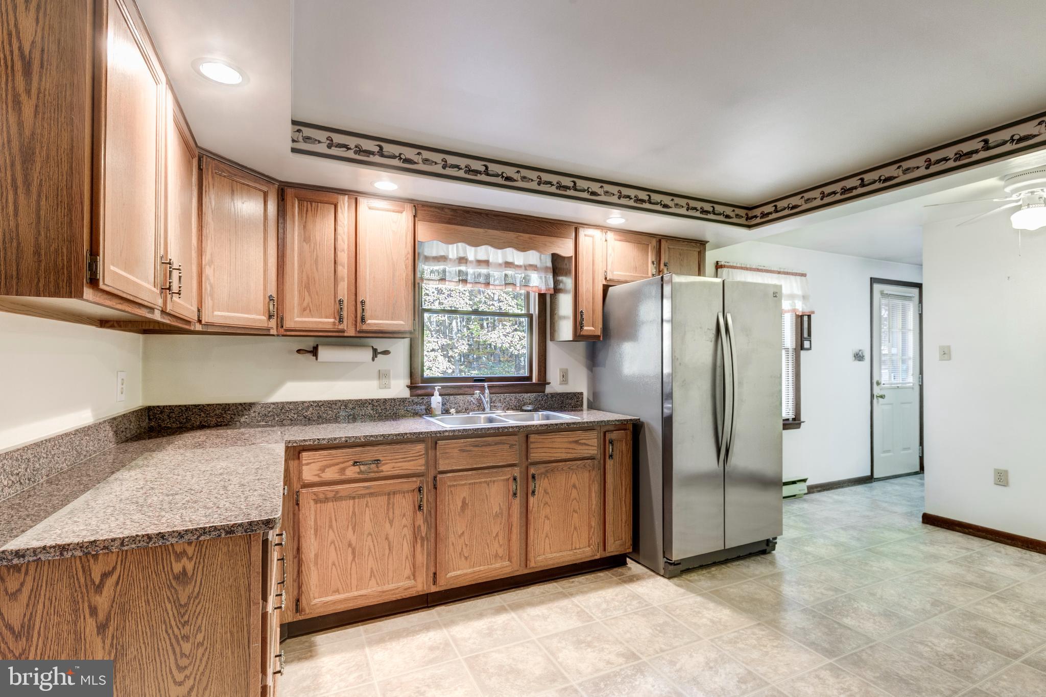 3870 Roop Road New Windsor, MD 21776 - Photo 6 of 59 a kitchen with stainless steel appliances granite countertop a refrigerator and a sink