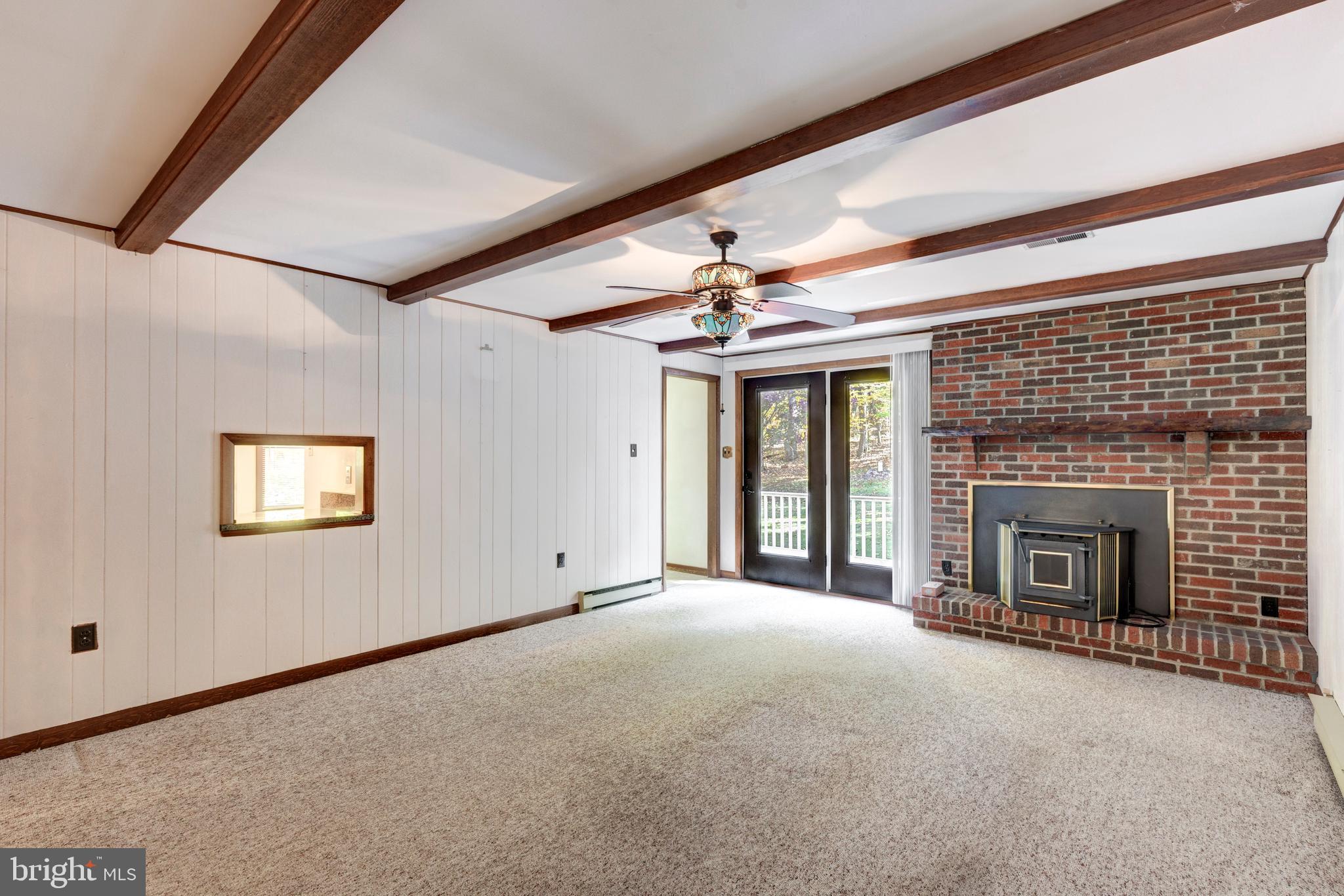 3870 Roop Road New Windsor, MD 21776 - Photo 10 of 59 a view of an empty room with a fireplace and a window