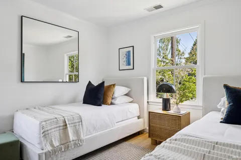 a bedroom with a bed and a painting on the wall