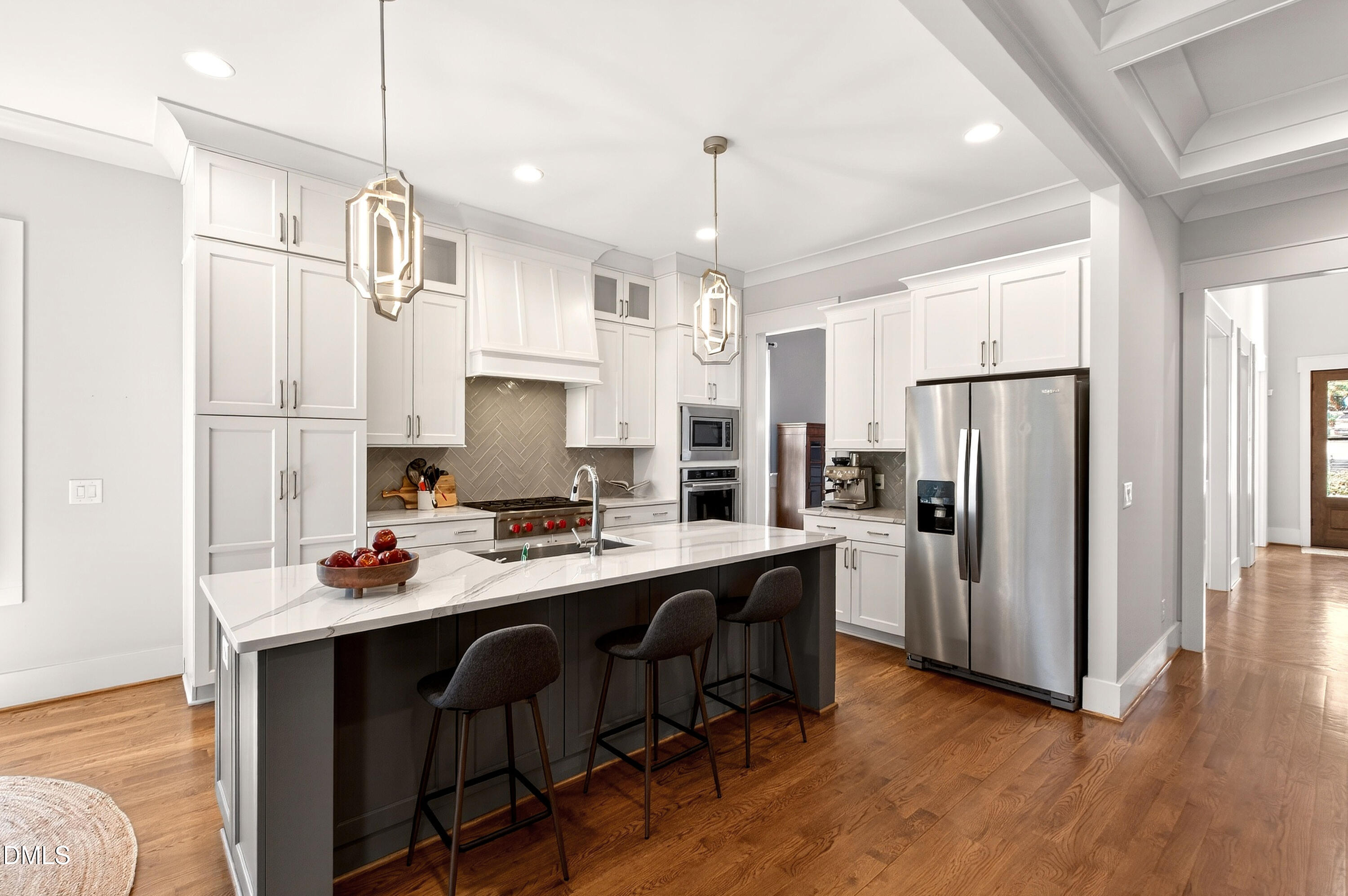 1116 Hymettus Court Raleigh, NC 27607 - Photo 16 of 69 a kitchen with stainless steel appliances a refrigerator a sink dishwasher a stove and white cabinets with wooden floor