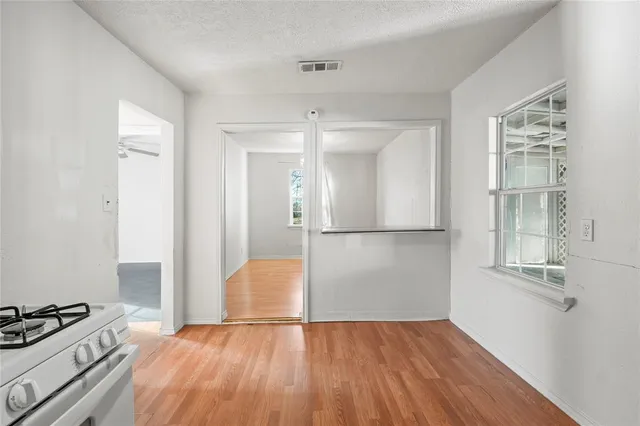a view of a kitchen with wooden floor and a kitchen