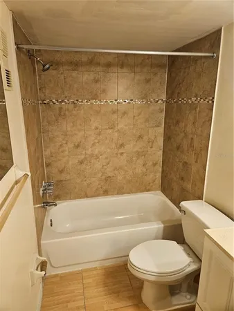 a bathroom with a toilet and a bathtub