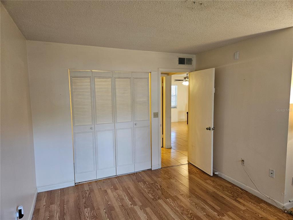 946 Virginia Street, Unit 104 Dunedin, FL 34698 - Photo 19 of 23 a view of an empty room and wooden floor