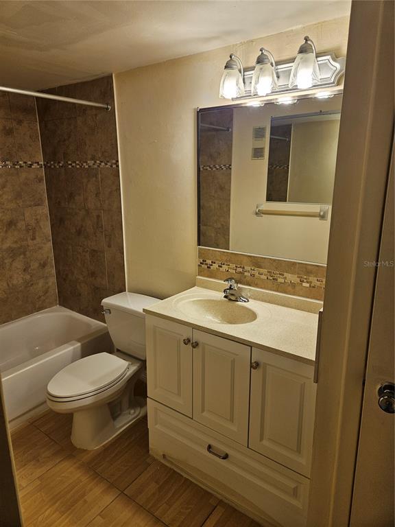 946 Virginia Street, Unit 104 Dunedin, FL 34698 - Photo 10 of 23 a bathroom with a sink toilet and shower