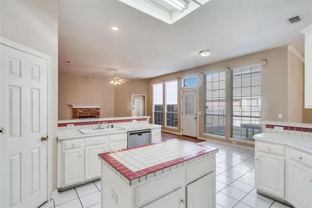 a kitchen with a stove sink and cabinets