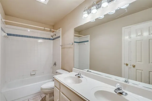 a bathroom with a tub a sink and mirror