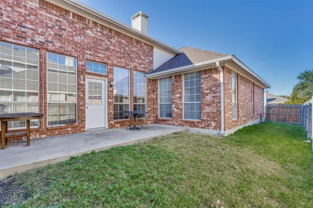 a view of a house with a yard and sitting area