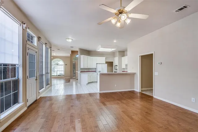 a view of a kitchen with a sink and a refrigerator
