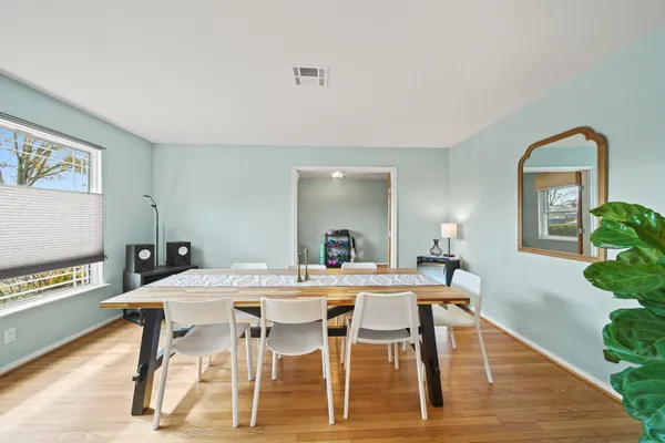 a view of a dining room with furniture and a potted plant