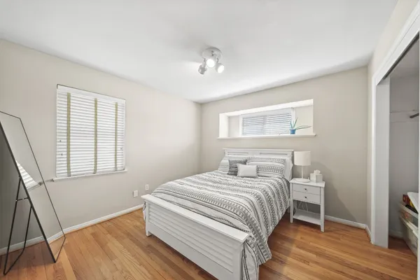 a bedroom with a bed and a window
