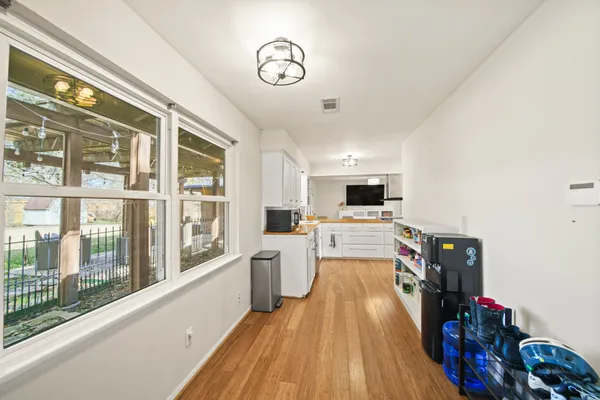 a view of a living room and kitchen with furniture wooden floor and window