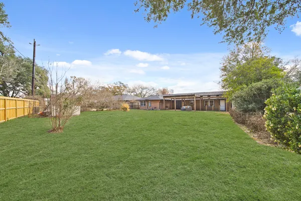 a view of green field with house in background