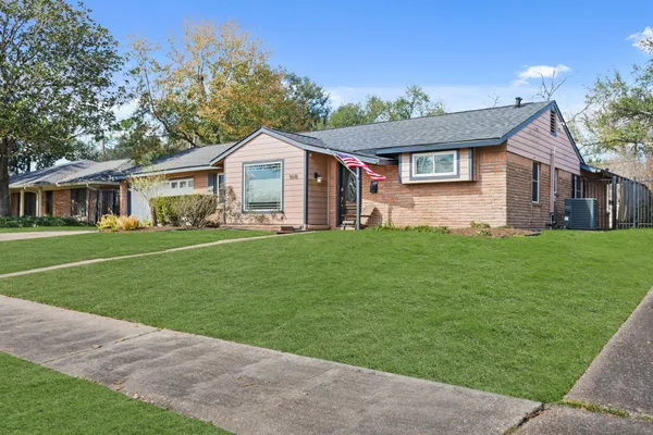 a front view of house with yard and green space