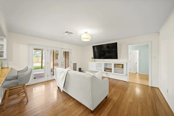 a living room with furniture and a flat screen tv