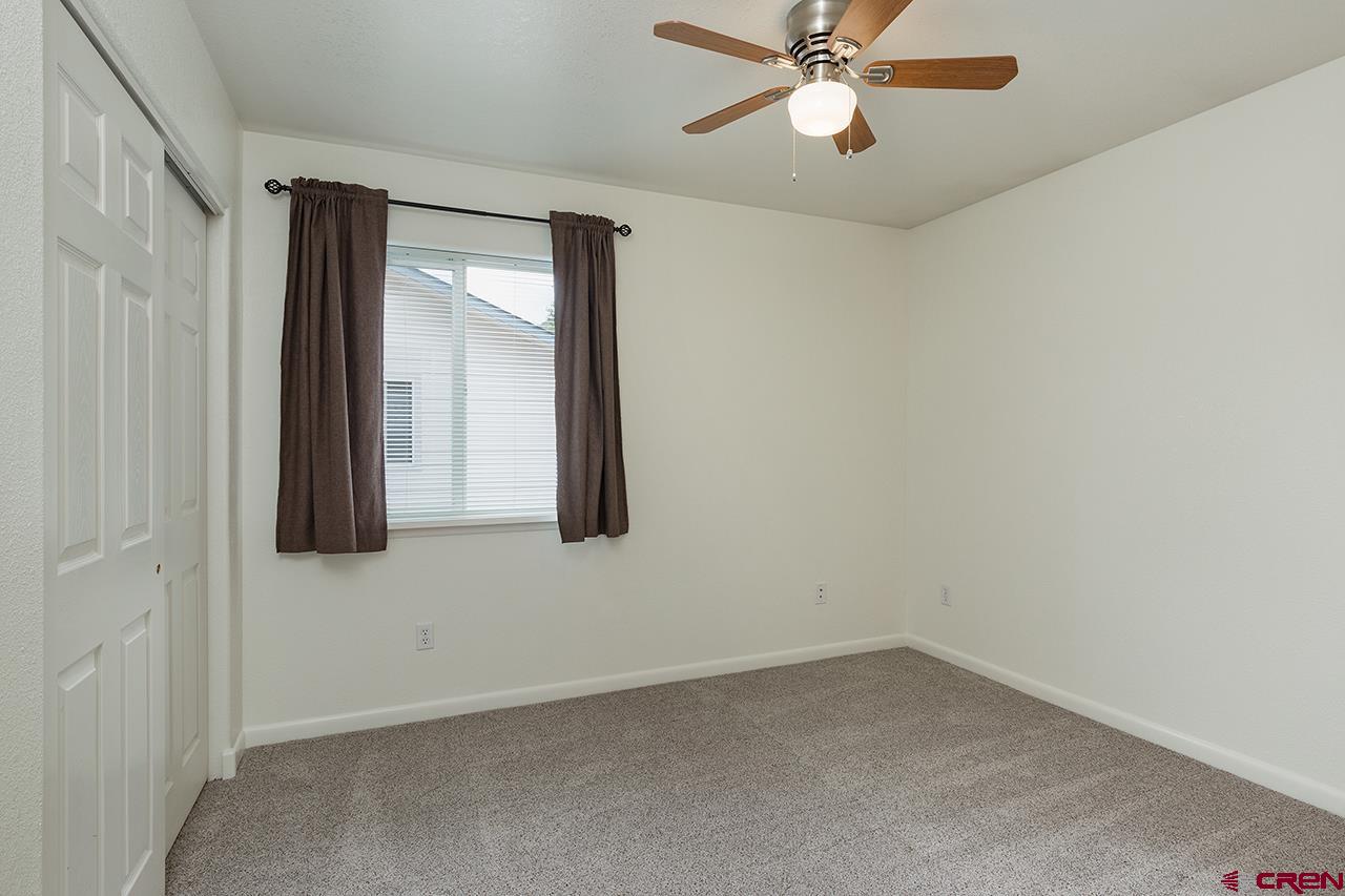 206 B Jenkins Ranch Road Durango, CO 81301 - Photo 15 of 27 an empty room with closet and a chandelier fan