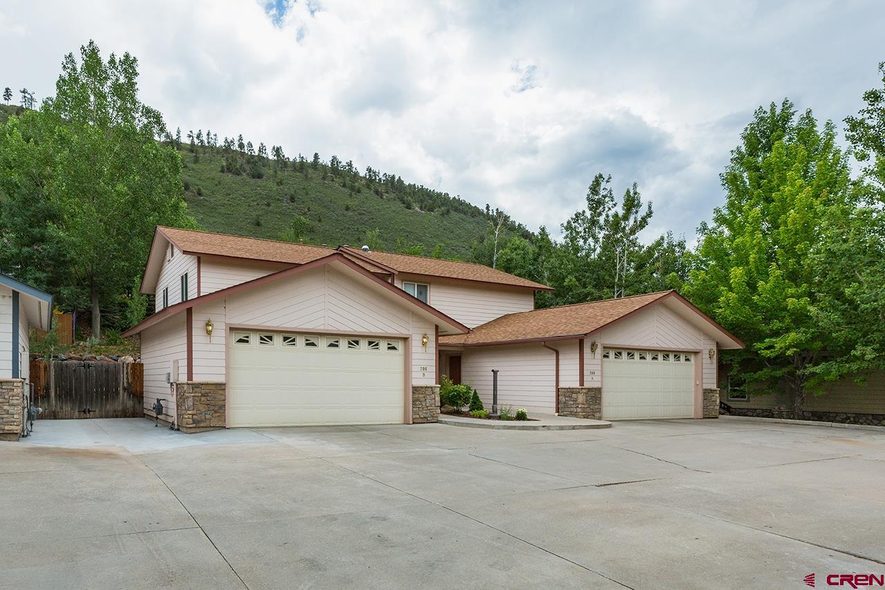 206 B Jenkins Ranch Road Durango, CO 81301 - Photo 3 of 27 a view of a house with a yard and large trees