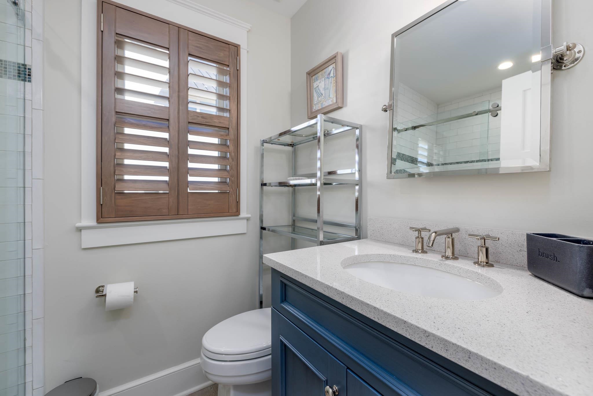 27 2nd Cape May, NJ 08204 - Photo 11 of 33 a bathroom with a sink a toilet and a window