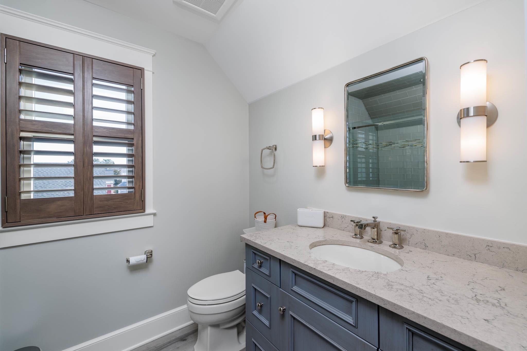 27 2nd Cape May, NJ 08204 - Photo 18 of 33 a bathroom with a granite countertop sink and a mirror