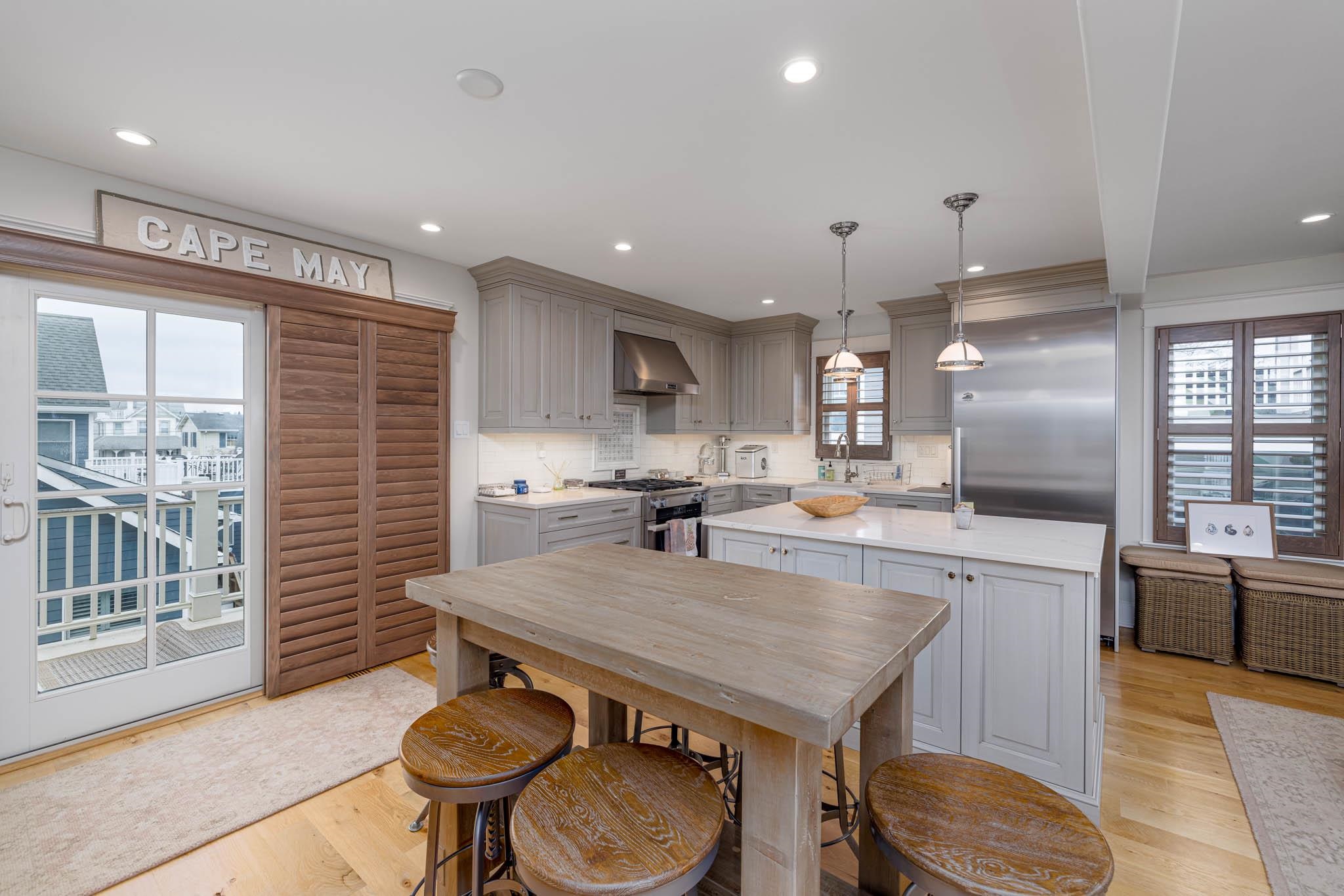 27 2nd Cape May, NJ 08204 - Photo 2 of 33 a kitchen with a table chairs microwave and cabinets
