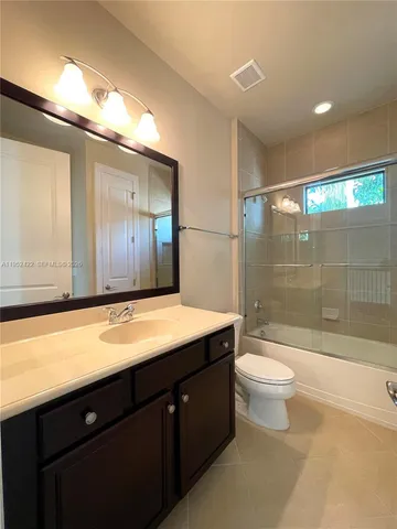 a spacious bedroom with a bed and window