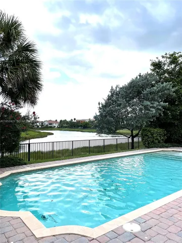 a view of a swimming pool with a lake view and mountain view