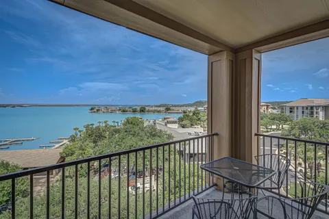 a view of a balcony with furniture and wooden floor