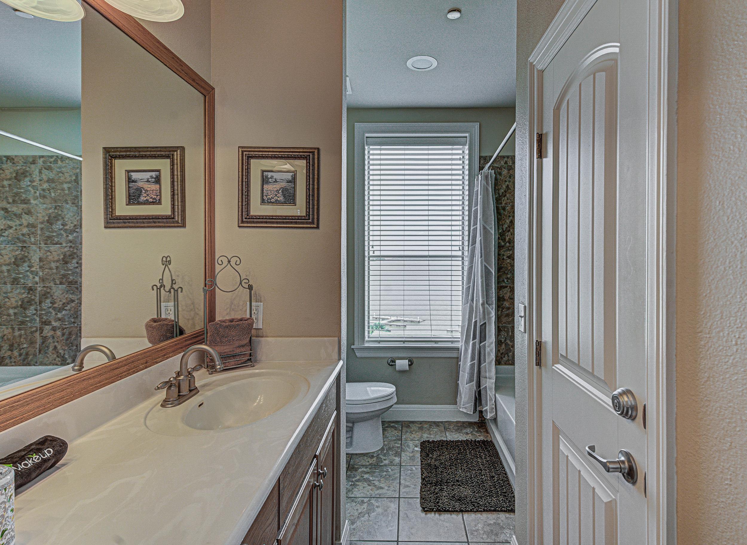 101 West Bank, Unit 51 Horseshoe Bay, TX 78657 - Photo 14 of 30 a bathroom with a sink a toilet and shower