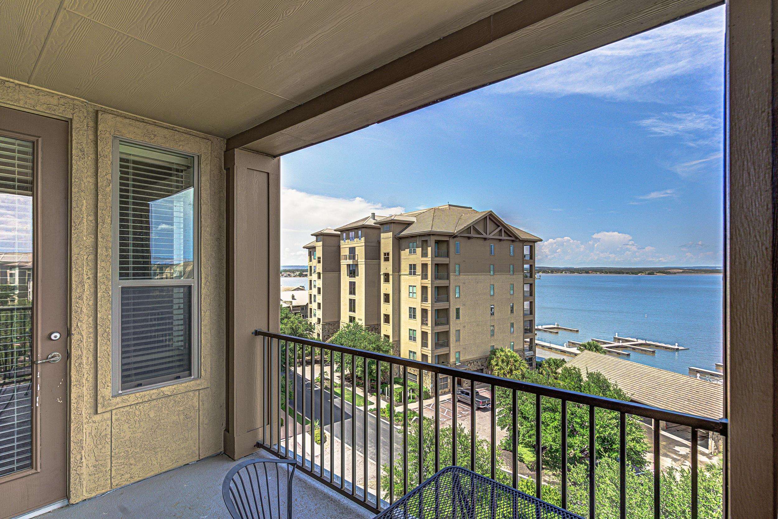 101 West Bank, Unit 51 Horseshoe Bay, TX 78657 - Photo 2 of 30 a view of a balcony with a floor to ceiling window and wooden floor