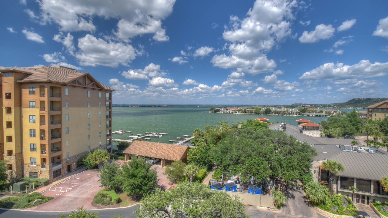 101 West Bank, Unit 51 Horseshoe Bay, TX 78657 - Photo 22 of 30 an aerial view of a house with garden space and lake view in back