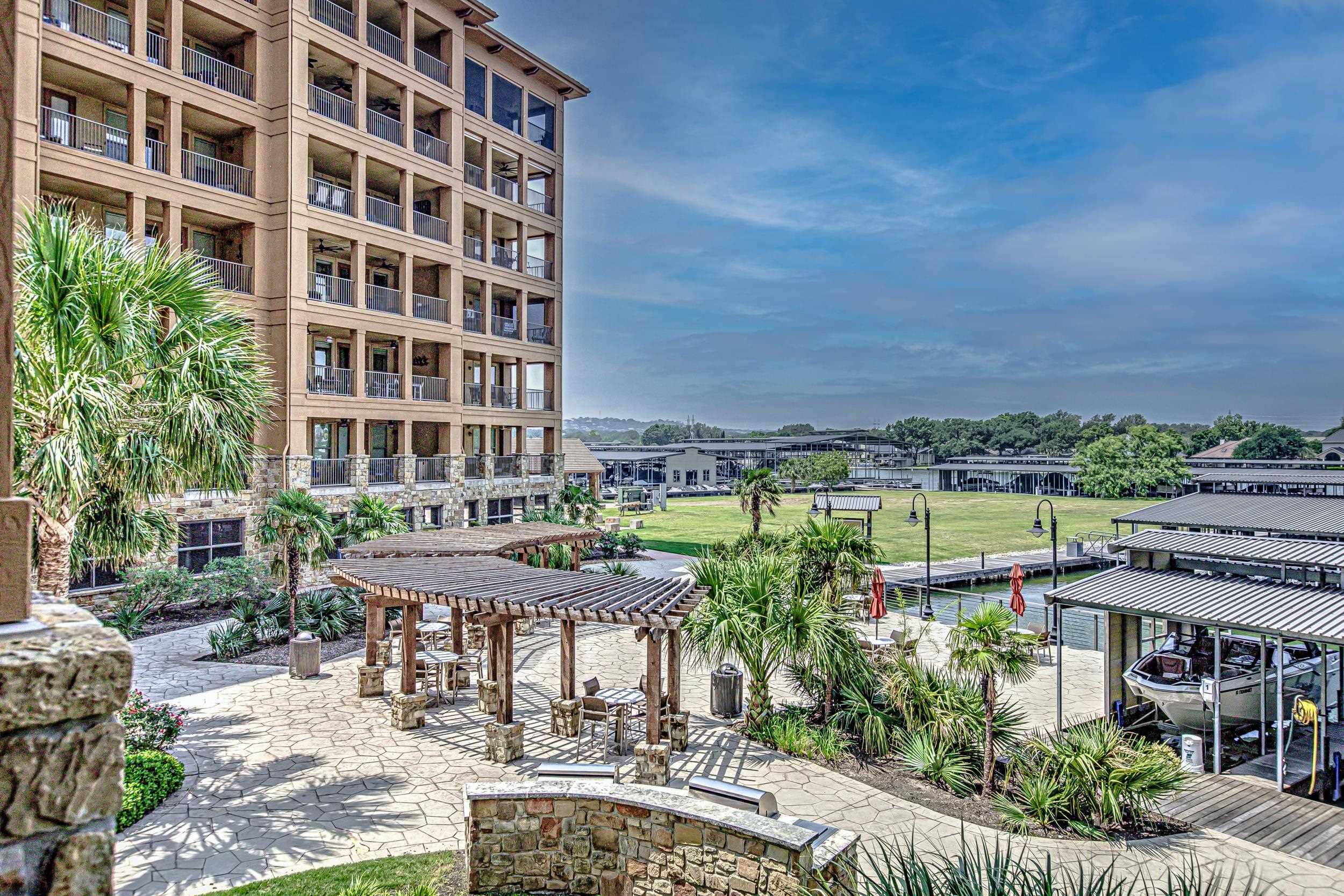 101 West Bank, Unit 51 Horseshoe Bay, TX 78657 - Photo 26 of 30 a view of a lake with a table and chairs