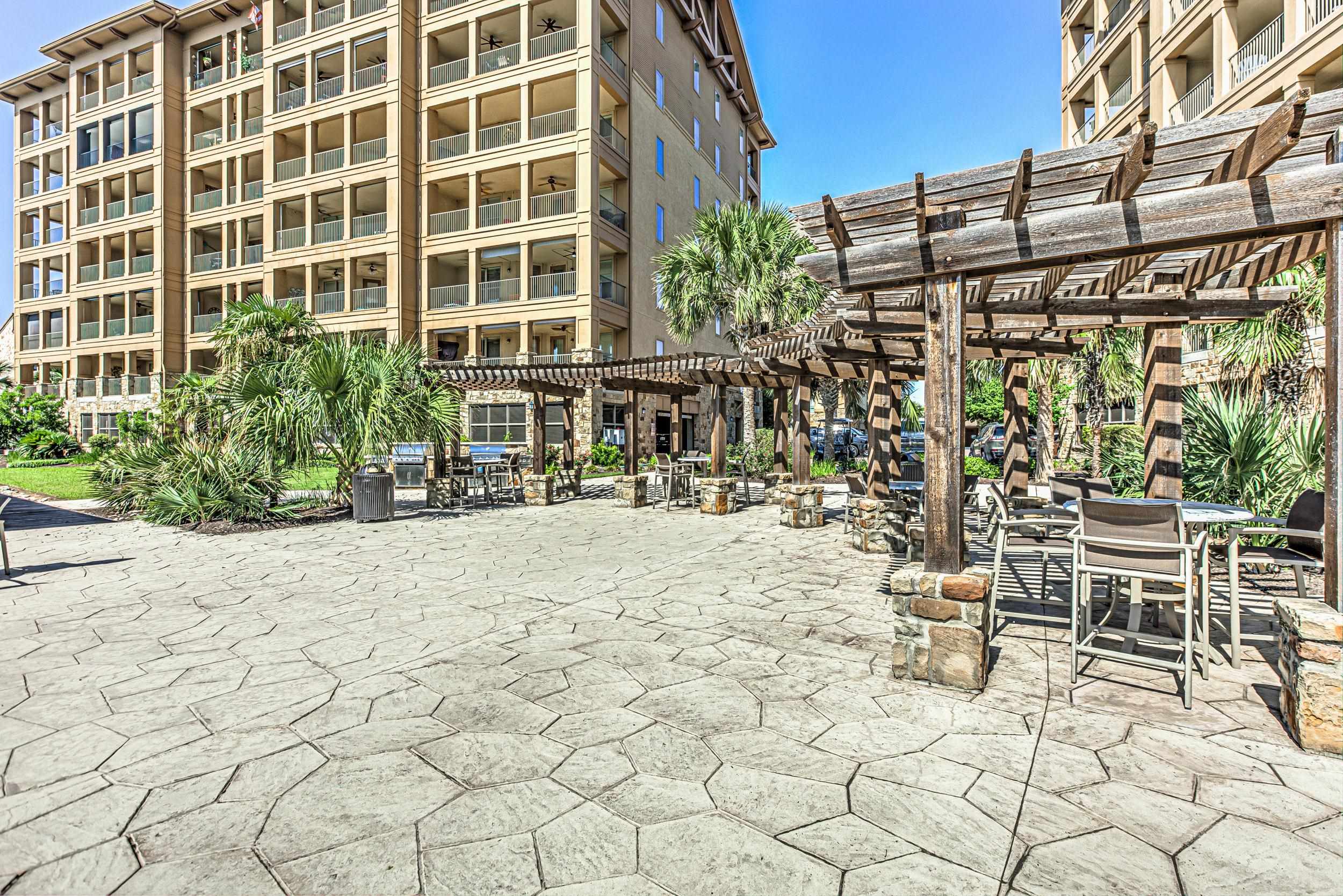 101 West Bank, Unit 51 Horseshoe Bay, TX 78657 - Photo 27 of 30 a row of palm trees and a building in a yard
