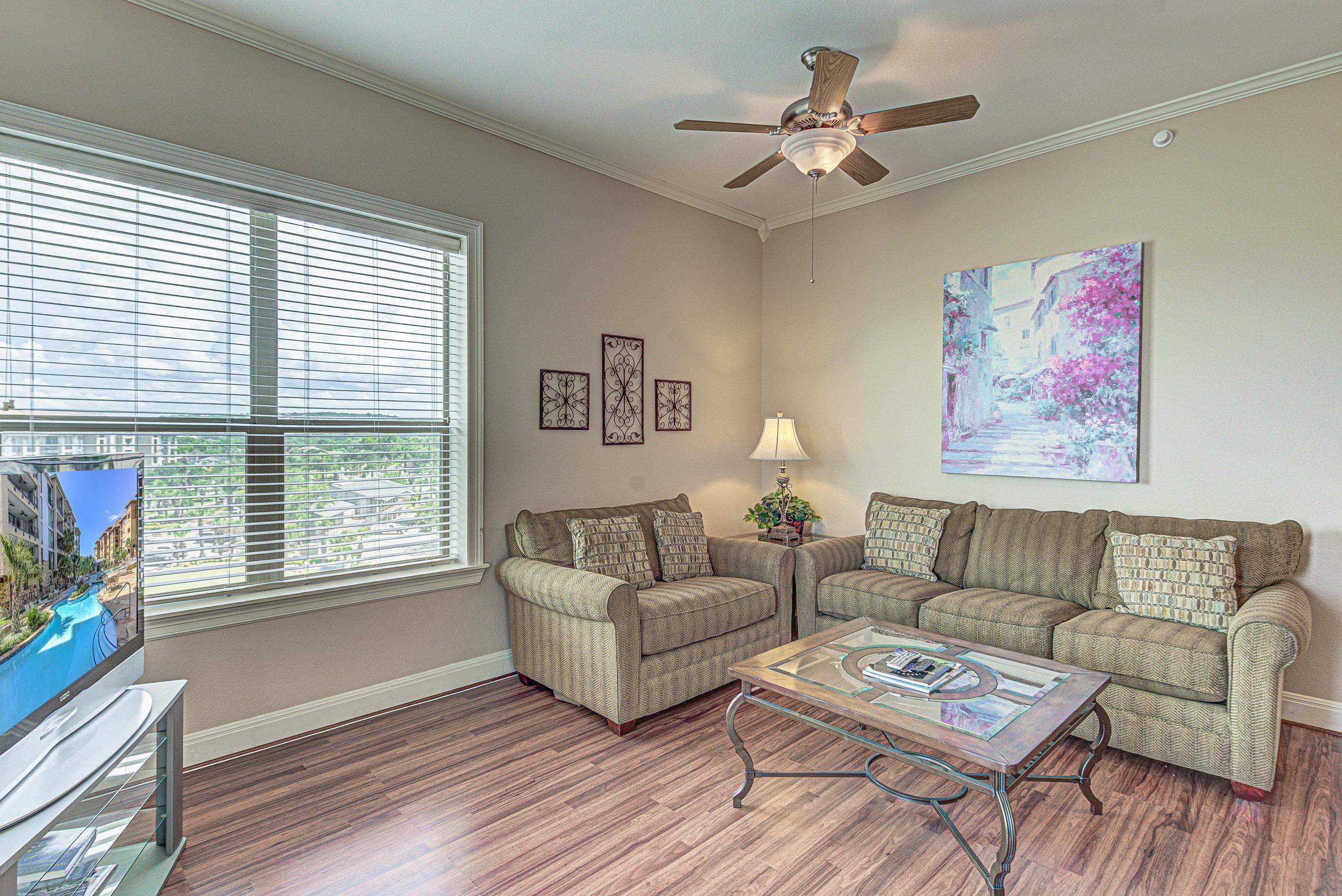 101 West Bank, Unit 51 Horseshoe Bay, TX 78657 - Photo 5 of 30 a living room with furniture and a large window