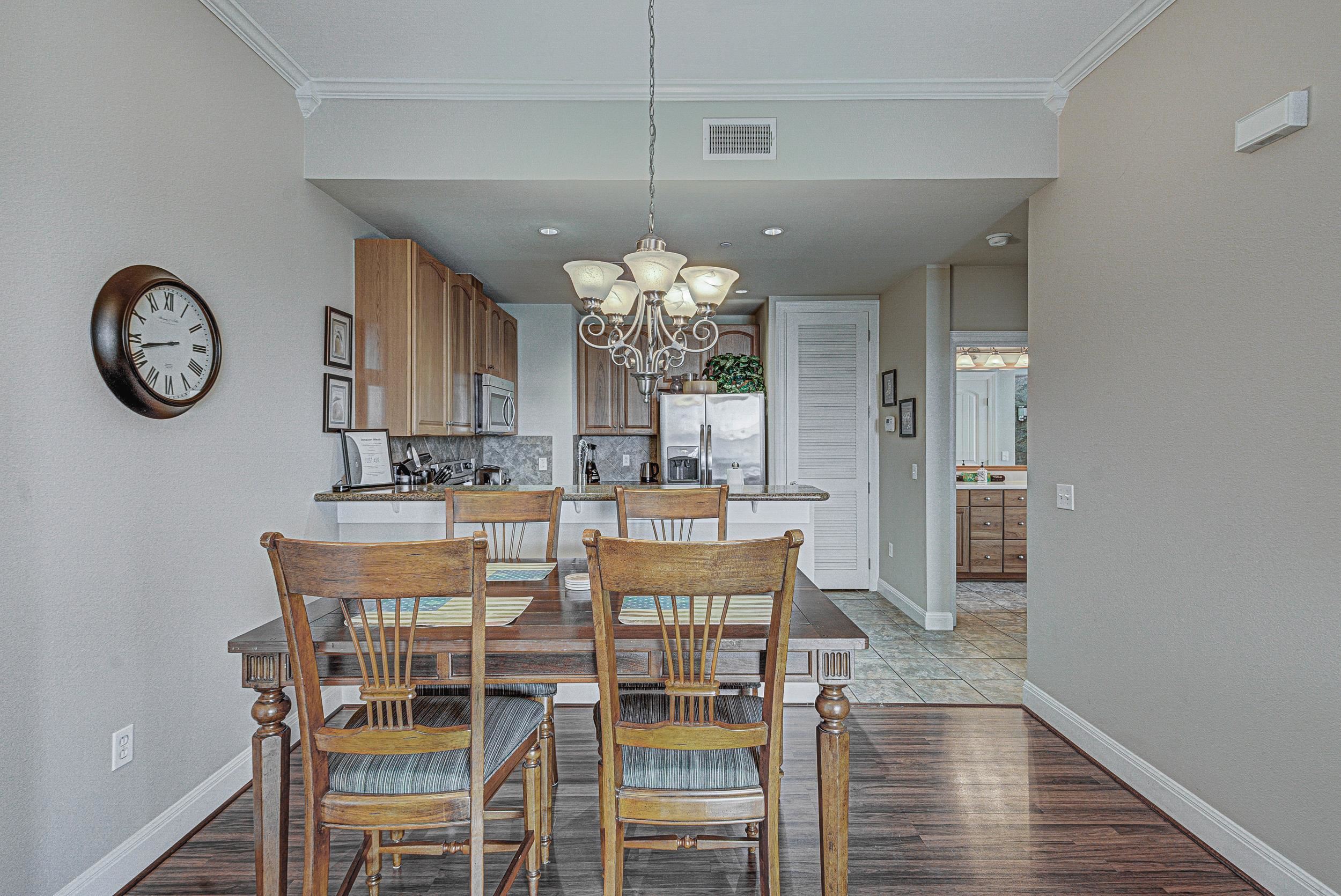101 West Bank, Unit 51 Horseshoe Bay, TX 78657 - Photo 6 of 30 a view of a dining room with furniture and wooden floor