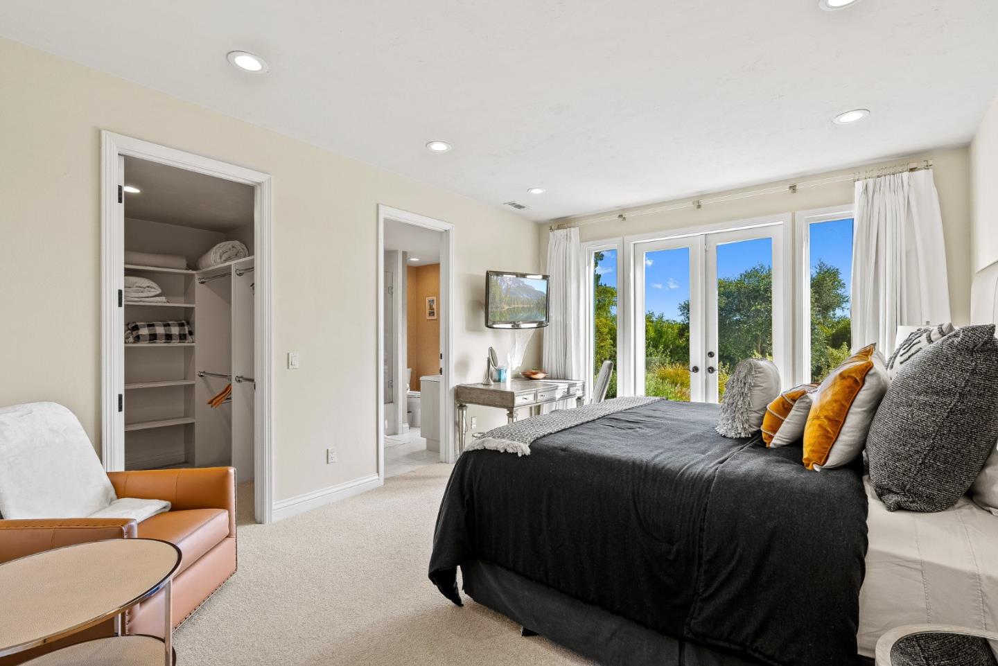 4038 Sunridge Road Pebble Beach, CA 93953 - Photo 27 of 48 a spacious bedroom with a bed and a couch