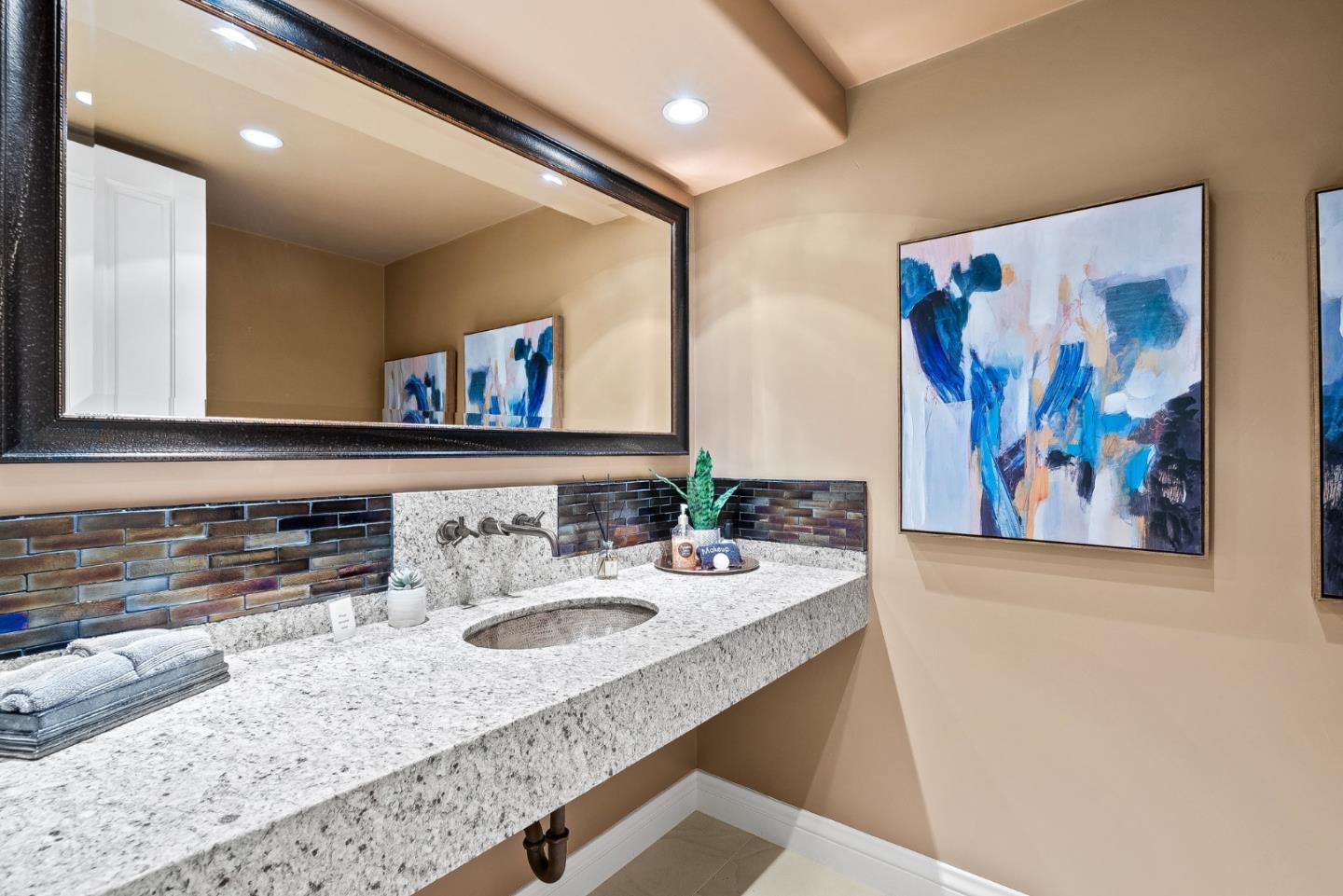 4038 Sunridge Road Pebble Beach, CA 93953 - Photo 28 of 48 a bathroom with a granite countertop sink mirror and vanity