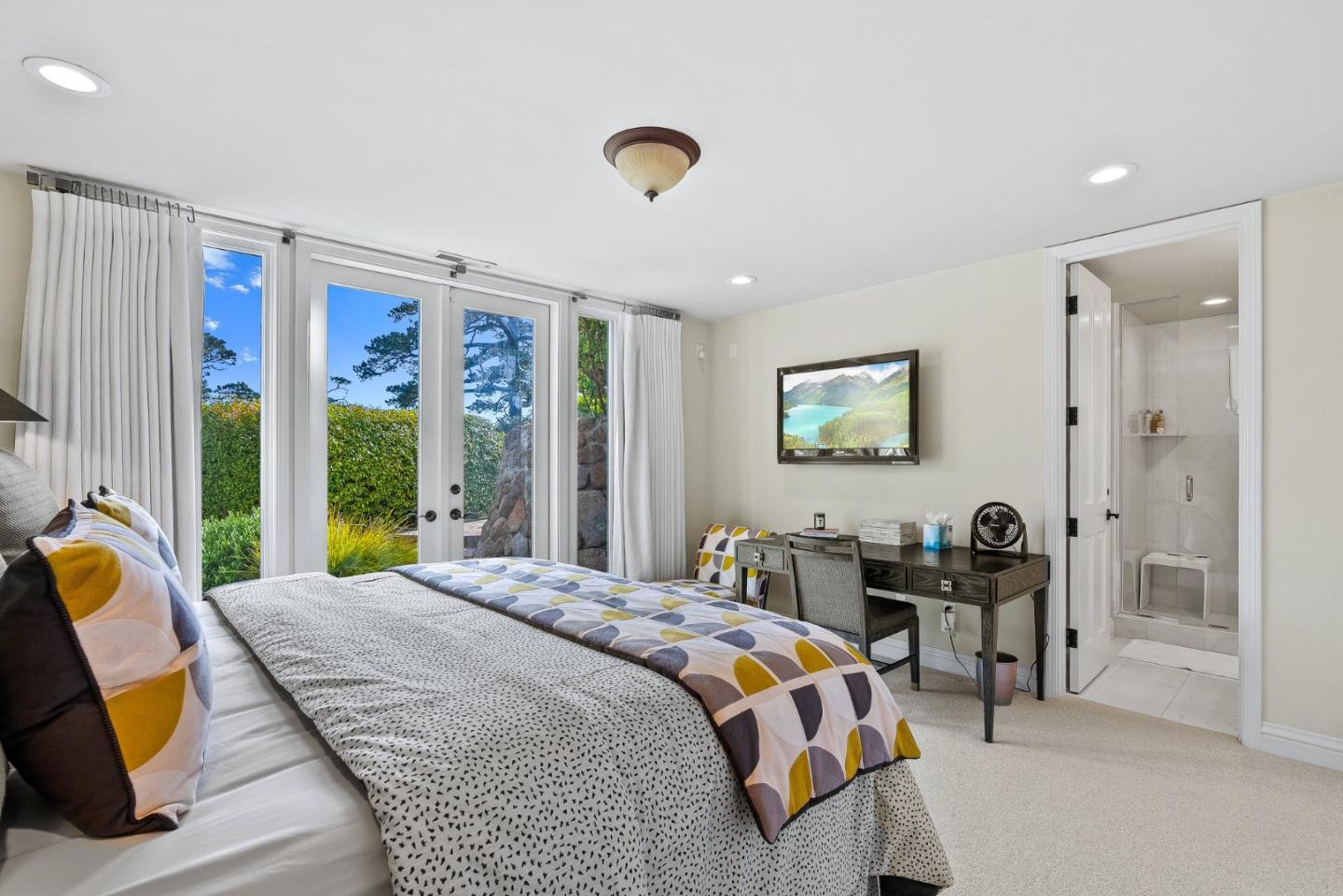 4038 Sunridge Road Pebble Beach, CA 93953 - Photo 33 of 48 a bedroom with a bed a table and a large window