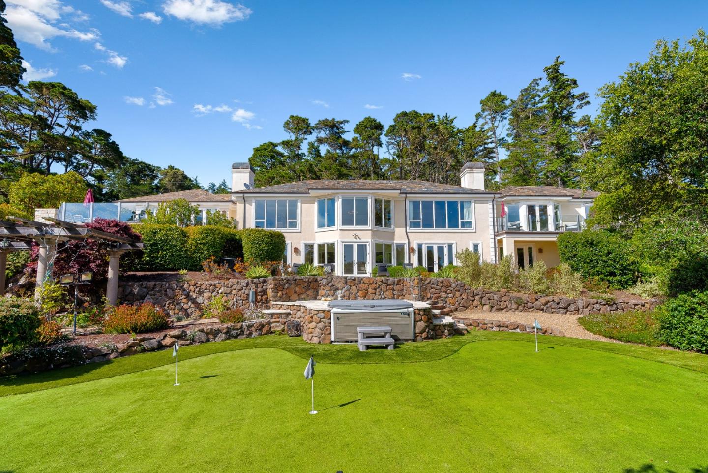 4038 Sunridge Road Pebble Beach, CA 93953 - Photo 37 of 48 a front view of a house with a garden and swimming pool