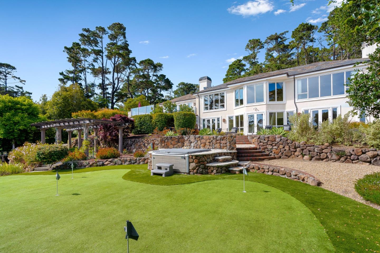 4038 Sunridge Road Pebble Beach, CA 93953 - Photo 38 of 48 a view of a house with backyard sitting area and swimming pool