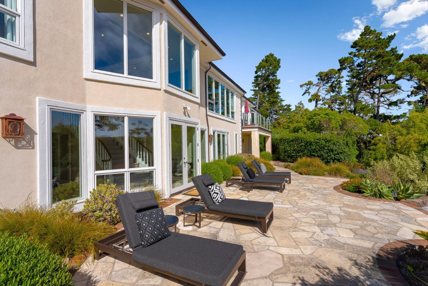 4038 Sunridge Road Pebble Beach, CA 93953 - Photo 41 of 48 a view of a patio with couches table and chairs and potted plants