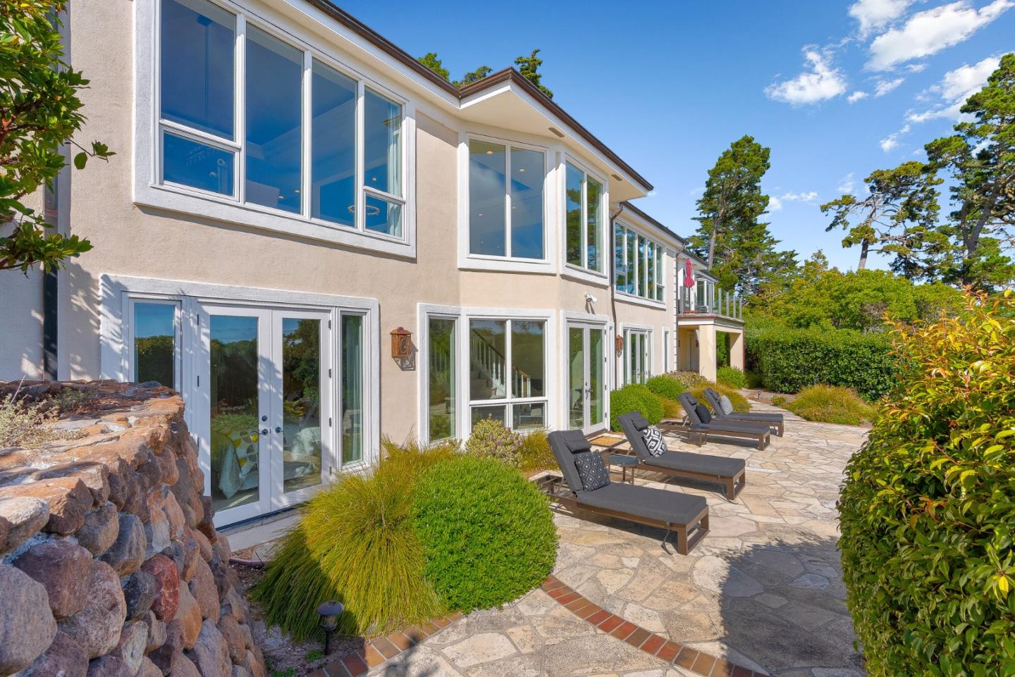 4038 Sunridge Road Pebble Beach, CA 93953 - Photo 43 of 48 a front view of a house with a garden and porch