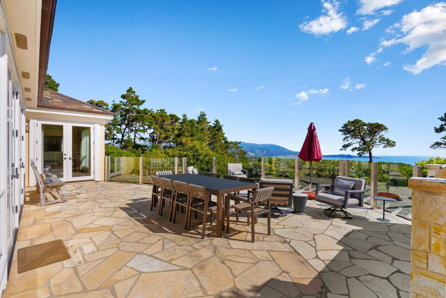 4038 Sunridge Road Pebble Beach, CA 93953 - Photo 44 of 48 a view of a patio with a dining table and chairs with a fire pit
