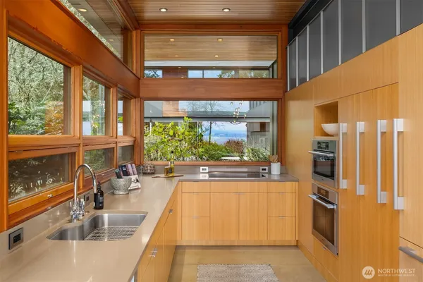 a kitchen with granite countertop a large window and a counter