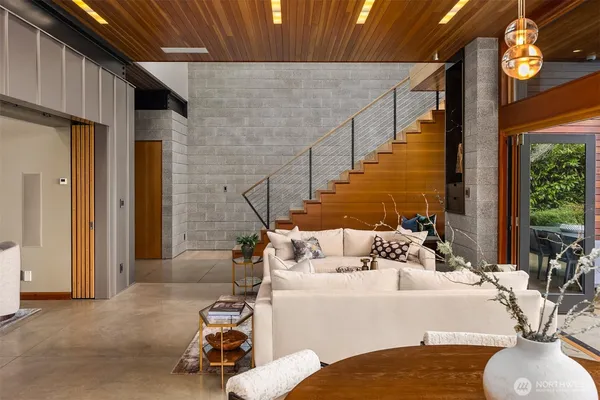 a living room with furniture and a chandelier